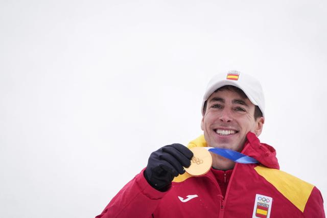 Gold medallist Spain's Oriol Cardona Coll celebrates on the podium after competing in the men's sprint ski mountaineering event during the Milano Cortina 2026 Winter Olympic Games at the Stelvio Ski Centre in Bormio (Valtellina) on February 19, 2026. (Photo by Dimitar DILKOFF / AFP)