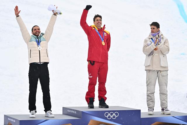 (From L) Silver medallist Individual Neutral Athletes' Nikita Filippov, gold medallist Spain's Oriol Cardona Coll and bronze medallist France's Thibault Anselmet celebrate on the podium after competing in the men's sprint ski mountaineering event during the Milano Cortina 2026 Winter Olympic Games at the Stelvio Ski Centre in Bormio (Valtellina) on February 19, 2026. (Photo by Fabrice COFFRINI / AFP)