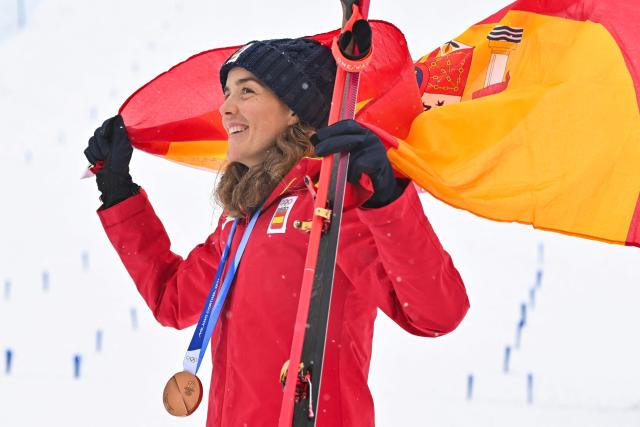 Bronze medallist Spain's Ana Alonso Rodriguez celebrates on the podium after competing in the women's sprint ski mountaineering event during the Milano Cortina 2026 Winter Olympic Games at the Stelvio Ski Centre in Bormio (Valtellina) on February 19, 2026. (Photo by Fabrice COFFRINI / AFP)