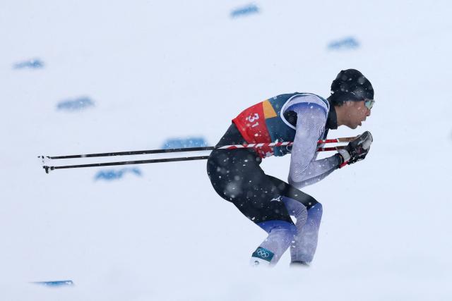 Japan's Akito Watabe competes in the cross-country of the nordic combined team sprint large hill event at Tesero Cross Country Stadium at Lago di Tesero (Val di Fiemme) during the Milano Cortina 2026 Winter Olympic Games on February 19, 2026. (Photo by Anne-Christine POUJOULAT / AFP)