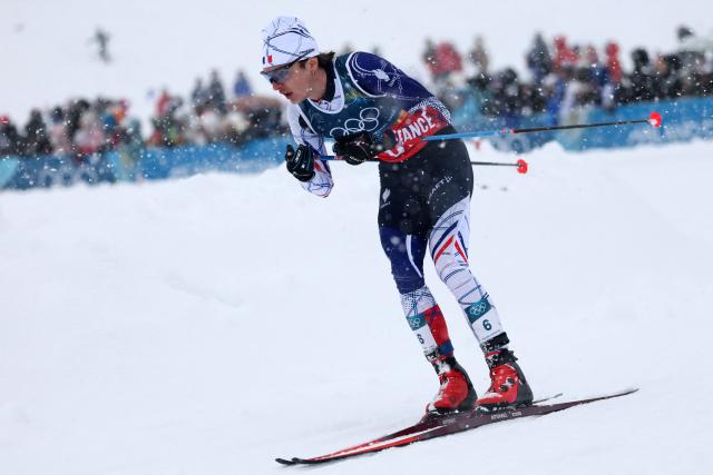 France's Marco Heinis competes in the cross-country of the nordic combined team sprint large hill event at Tesero Cross Country Stadium at Lago di Tesero (Val di Fiemme) during the Milano Cortina 2026 Winter Olympic Games on February 19, 2026. (Photo by Anne-Christine POUJOULAT / AFP)