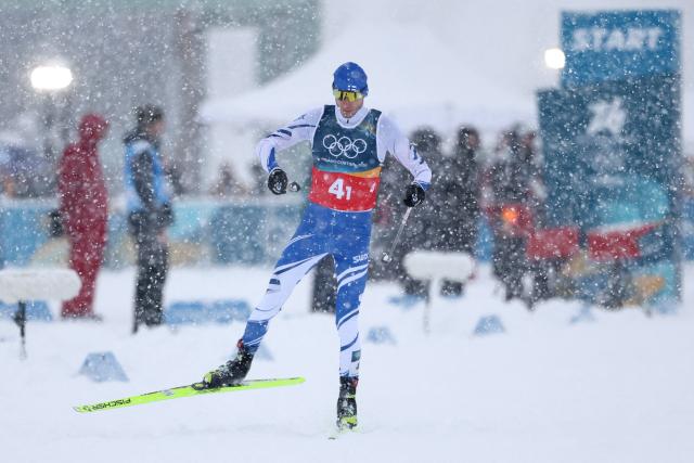 Finland's Ilkka Herola competes in the cross-country of the nordic combined team sprint large hill event at Tesero Cross Country Stadium at Lago di Tesero (Val di Fiemme) during the Milano Cortina 2026 Winter Olympic Games on February 19, 2026. (Photo by Anne-Christine POUJOULAT / AFP)