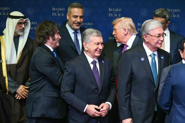 US President Donald Trump shakes hands with Argentina's President Javier Milei (2L) as leaders gather during a group photo during the inaugural meeting of the "Board of Peace" at the US Institute of Peace in Washington, DC, on February 19, 2026. President Trump on Thursday gathers allies to inaugurate the "Board of Peace," his new institution focused on progress on Gaza but whose ambitions reach much further. Around two dozen world leaders or other senior officials have come to Washington for the meeting -- including several of Trump's authoritarian-leaning friends and virtually none of the European democrats that traditionally sign on to US initiatives. (Photo by SAUL LOEB / AFP)