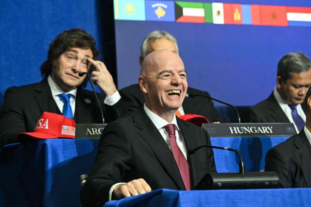 (L/R) Argentina's President Javier Milei and FIFA President Gianni Infantino attend the inaugural meeting of the "Board of Peace" hosted by US President Donald Trump at the US Institute of Peace in Washington, DC, on February 19, 2026. President Trump on Thursday gathers allies to inaugurate the "Board of Peace," his new institution focused on progress on Gaza but whose ambitions reach much further. Around two dozen world leaders or other senior officials have come to Washington for the meeting -- including several of Trump's authoritarian-leaning friends and virtually none of the European democrats that traditionally sign on to US initiatives. (Photo by SAUL LOEB / AFP)