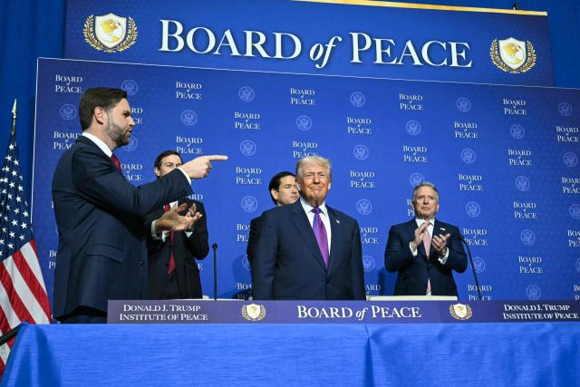 US Vice President JD Vance (L) gestures as US President Donald Trump (C) arrives for the inaugural meeting of the "Board of Peace" at the US Institute of Peace in Washington, DC, on February 19, 2026. President Trump on Thursday gathers allies to inaugurate the "Board of Peace," his new institution focused on progress on Gaza but whose ambitions reach much further. Around two dozen world leaders or other senior officials have come to Washington for the meeting -- including several of Trump's authoritarian-leaning friends and virtually none of the European democrats that traditionally sign on to US initiatives. (Photo by SAUL LOEB / AFP)
