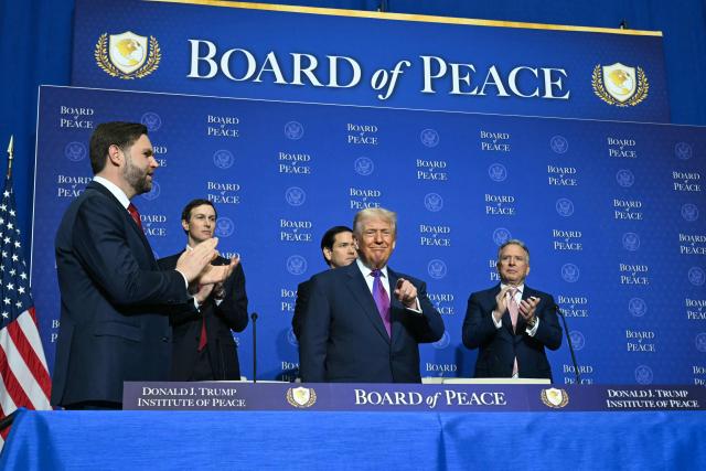 US President Donald Trump (C) gestures as he arrives for the inaugural meeting of the "Board of Peace" at the US Institute of Peace in Washington, DC, on February 19, 2026. President Trump on Thursday gathers allies to inaugurate the "Board of Peace," his new institution focused on progress on Gaza but whose ambitions reach much further. Around two dozen world leaders or other senior officials have come to Washington for the meeting -- including several of Trump's authoritarian-leaning friends and virtually none of the European democrats that traditionally sign on to US initiatives. (Photo by SAUL LOEB / AFP)