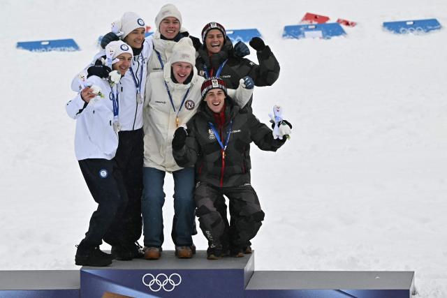(From L) Silver medalist Finland's Ilkka Herola and Finland's Eero Hirvonen, gold medallist Norway's Jens Luraas Oftebro, Norway's Andreas Skoglund, and bronze medallist Austria's Johannes Lamparter and Austria's Stefan Rettenegger celebrate on the podium following the nordic combined team sprint large hill event at Tesero Cross Country Stadium at Lago di Tesero (Val di Fiemme) during the Milano Cortina 2026 Winter Olympic Games on February 19, 2026.  (Photo by Javier SORIANO / AFP)