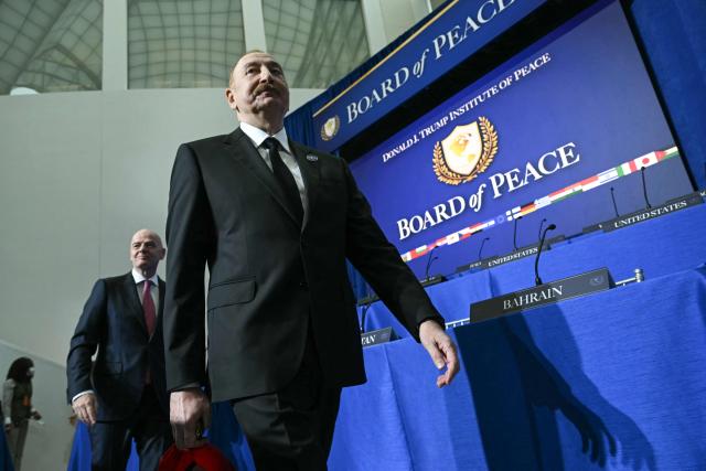 (L/R) FIFA President Gianni Infantino and Azerbaijan's President Ilham Aliyev arrive to attend the inaugural meeting of the "Board of Peace" hosted by US President Donald Trump at the US Institute of Peace in Washington, DC, on February 19, 2026. President Trump on Thursday gathers allies to inaugurate the "Board of Peace," his new institution focused on progress on Gaza but whose ambitions reach much further. Around two dozen world leaders or other senior officials have come to Washington for the meeting -- including several of Trump's authoritarian-leaning friends and virtually none of the European democrats that traditionally sign on to US initiatives. (Photo by SAUL LOEB / AFP)