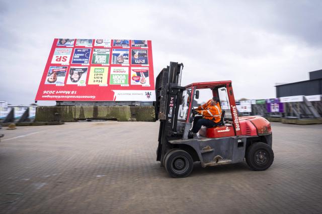 An employee load signs onto a truck at a manufacturer and supplier of election signs in the run-up to the municipal elections in Huissen on February 19, 2026. (Photo by Jeroen Jumelet / ANP / AFP) / Netherlands OUT