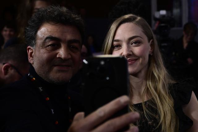 US actress Amanda Seyfried (R) poses for a selfie after a press conference for the film 'The Testament of Ann Lee' presented in Berlinale Special Gala at the 76th Berlinale, Europe's first major film festival of the year, in Berlin on February 19, 2026. (Photo by John MACDOUGALL / AFP)