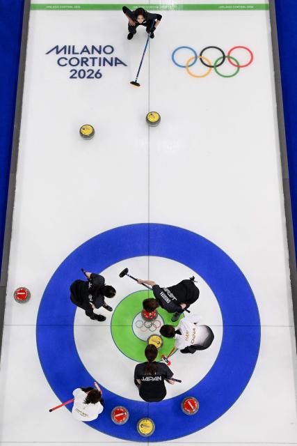 Japan's team competes in the curling women's round robin between Japan and China during the Milano Cortina 2026 Winter Olympic Games at the Cortina Curling Olympic Stadium in Cortina d’Ampezzo on February 19, 2026. (Photo by Franзois-Xavier MARIT / AFP)