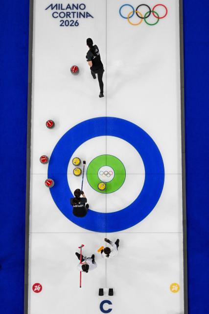 Japan's team copetes in the curling women's round robin between Japan and China during the Milano Cortina 2026 Winter Olympic Games at the Cortina Curling Olympic Stadium in Cortina d’Ampezzo on February 19, 2026. (Photo by Franзois-Xavier MARIT / AFP)