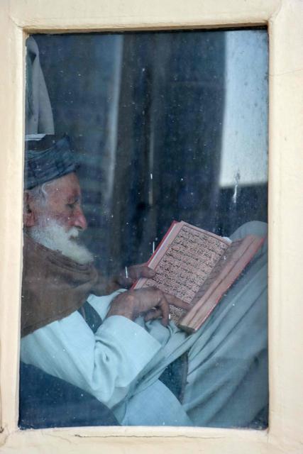 An Afghan man reads the holy Koran on the first day of the Islamic holy month of Ramadan at Jami Masjid, also known as the Great Mosque of Herat in Herat on February 19, 2026. (Photo by Mohsen KARIMI / AFP)