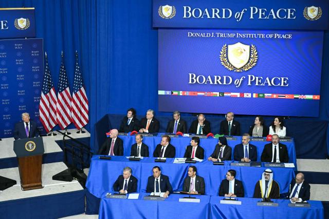 US President Donald Trump (L) delivers remarks during the inaugural meeting of the "Board of Peace" at the US Institute of Peace in Washington, DC, on February 19, 2026. President Trump on Thursday gathers allies to inaugurate the "Board of Peace," his new institution focused on progress on Gaza but whose ambitions reach much further. Around two dozen world leaders or other senior officials have come to Washington for the meeting -- including several of Trump's authoritarian-leaning friends and virtually none of the European democrats that traditionally sign on to US initiatives. (Photo by SAUL LOEB / AFP)