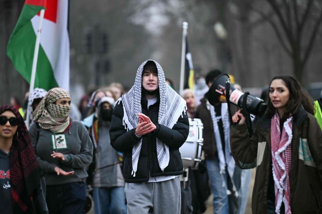 Demonstrators protest outside of the US Institute of Peace as President Donald Trump hosts the inaugural meeting of the "Board of Peace" at the in Washington, DC, on February 19, 2026. President Trump on Thursday gathers allies to inaugurate the "Board of Peace," his new institution focused on progress on Gaza but whose ambitions reach much further. Around two dozen world leaders or other senior officials have come to Washington for the meeting -- including several of Trump's authoritarian-leaning friends and virtually none of the European democrats that traditionally sign on to US initiatives. (Photo by Brendan SMIALOWSKI / AFP)