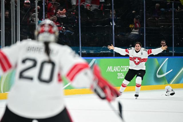 Switzerland's #25 Alina Muller  celebrates after winning the women's bronze medal ice hockey match between Switzerland and Sweden at the Milano Santagiulia Ice Hockey Arena during the Milano Cortina 2026 Winter Olympic Games in Milan, on February 19, 2026. (Photo by JULIEN DE ROSA / AFP)