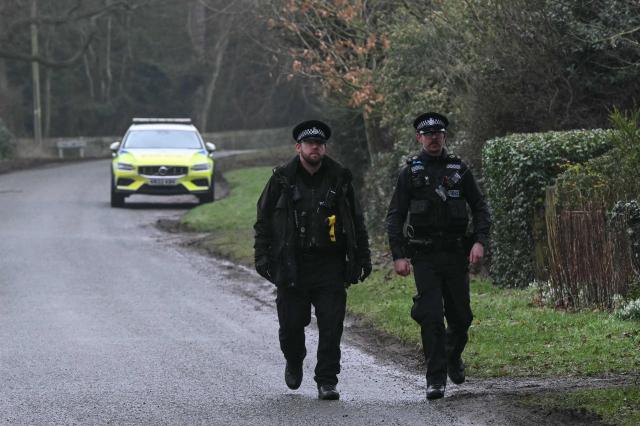 Policemen walk near an entrance to Wood Farm on the royal family's Sandringham Estate in Norfolk, eastern England on February 19, 2026, where former prince Andrew was arrested earlier in the day. Britain's royal family was in crisis on February 19 as former prince Andrew was in police custody after being arrested on suspicion of misconduct for his links to late US sex offender Jeffrey Epstein. (Photo by JUSTIN TALLIS / AFP)