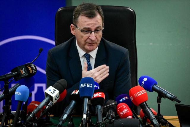 French prosecutor of Lyon Thierry Dran gestures as he addresses the audience during a press conference, a week after the killing in Lyon of far-right activist Quentin Deranque at Lyon courthouse on February 19, 2026. As all the suspects "deny intent to kill" Thierry Dran informed that the prosecution requests seven suspects to be charged with "voluntary homicide" and the four other suspects have been released. (Photo by OLIVIER CHASSIGNOLE / AFP)