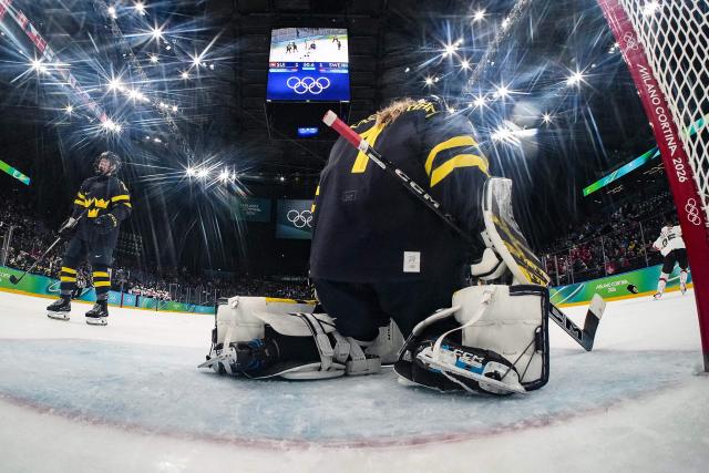 Sweden's #01 Ebba Svensson Traff (R) reacts after conceding the winning goal for Switzerland during the women's bronze medal ice hockey match between Switzerland and Sweden at the Milano Santagiulia Ice Hockey Arena during the Milano Cortina 2026 Winter Olympic Games in Milan, on February 19, 2026. (Photo by POOL / AFP)