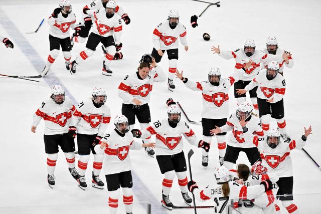 Switzerland's players celebrate the team's 3-2 win of the women's bronze medal ice hockey match between Switzerland and Sweden at the Milano Santagiulia Ice Hockey Arena during the Milano Cortina 2026 Winter Olympic Games in Milan, on February 19, 2026. (Photo by Alexander NEMENOV / AFP)