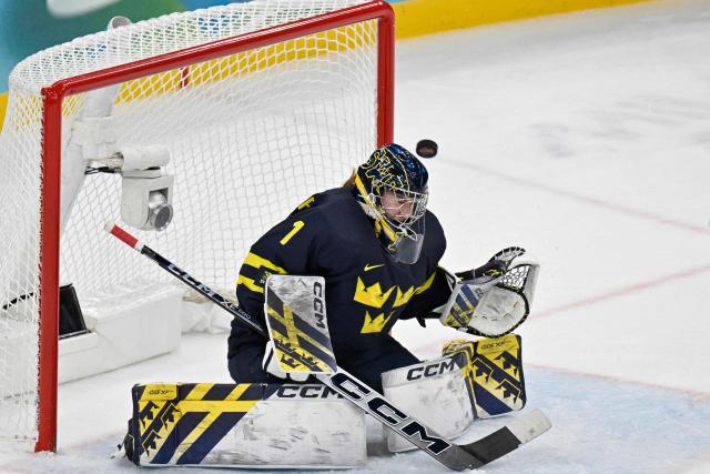 Sweden's #01 Ebba Svensson Traff fails to save the goal from Switzerland's #25 Alina Muller (not pictured) at the end of the women's bronze medal ice hockey match between Switzerland and Sweden at the Milano Santagiulia Ice Hockey Arena during the Milano Cortina 2026 Winter Olympic Games in Milan, on February 19, 2026. (Photo by Alexander NEMENOV / AFP)