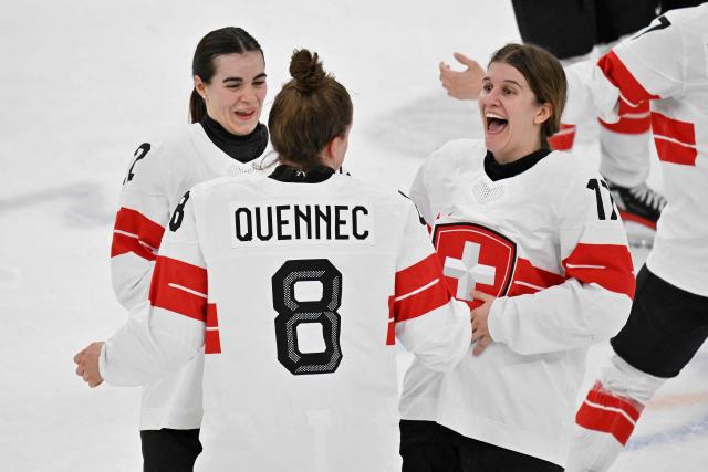 (From L) Switzerland's #22 Sinja Leemann, Switzerland's #08 Kaleigh Quennec and  Switzerland's #17 Lara Christen celebrates after winning the women's bronze medal ice hockey match between Switzerland and Sweden at the Milano Santagiulia Ice Hockey Arena during the Milano Cortina 2026 Winter Olympic Games in Milan, on February 19, 2026. (Photo by Alexander NEMENOV / AFP)
