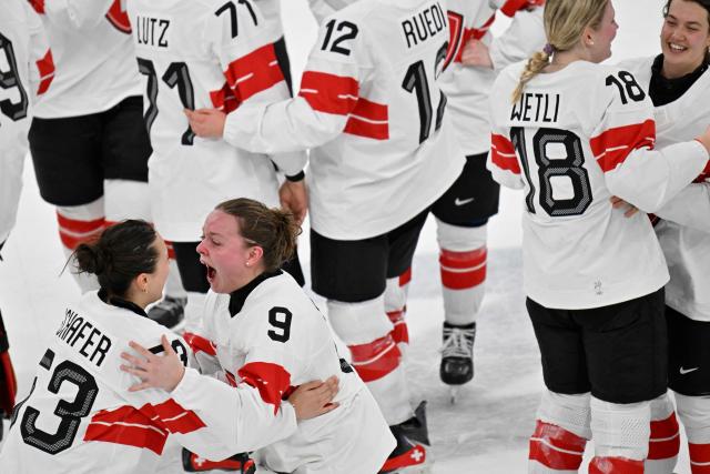 Switzerland's #53 Vanessa Schaefer (L) and Sweden's #09 Jessica Adolfsson celebrate the team's 3-2 win of the women's bronze medal ice hockey match between Switzerland and Sweden at the Milano Santagiulia Ice Hockey Arena during the Milano Cortina 2026 Winter Olympic Games in Milan, on February 19, 2026. (Photo by Alexander NEMENOV / AFP)