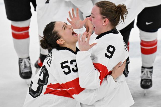 Switzerland's #53 Vanessa Schaefer (L) and Sweden's #09 Jessica Adolfsson celebrate the team's 3-2 win of the women's bronze medal ice hockey match between Switzerland and Sweden at the Milano Santagiulia Ice Hockey Arena during the Milano Cortina 2026 Winter Olympic Games in Milan, on February 19, 2026. (Photo by Alexander NEMENOV / AFP)
