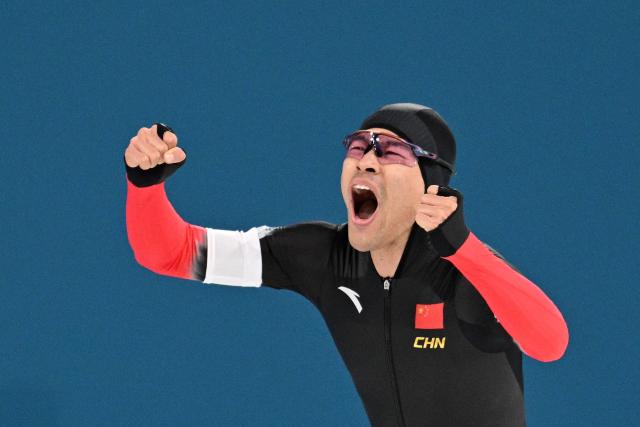 China's Ning Zhongyan celebrates after creating an Olympic Record in the speed skating men's 1500m during the Milano Cortina 2026 Winter Olympic Games at Milano Speed Skating Stadium in Milan on February 19, 2026. (Photo by Daniel MUNOZ / AFP)