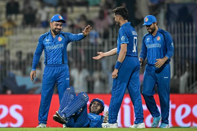 Afghanistan's Abdollah Ahmadzai (2R) celebrates with teammates after taking a catch to dismiss Canada's Dilon Heyliger during the 2026 ICC Men's T20 Cricket World Cup group stage match between Afghanistan and Canada at the MA Chidambaram Stadium in Chennai on February 19, 2026. (Photo by R. Satish BABU / AFP)