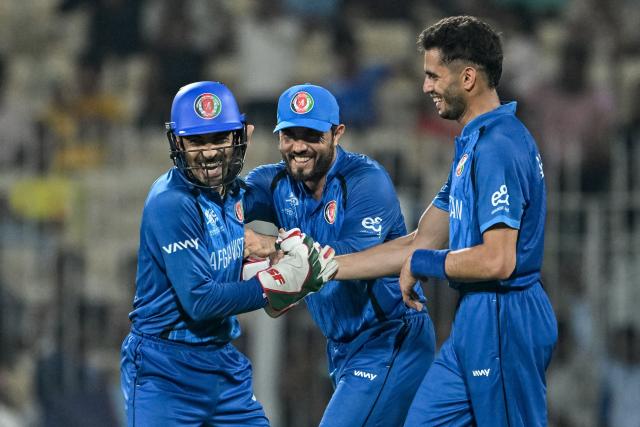 Afghanistan's Abdollah Ahmadzai (R) celebrates with teammates after taking a catch to dismiss Canada's Dilon Heyliger during the 2026 ICC Men's T20 Cricket World Cup group stage match between Afghanistan and Canada at the MA Chidambaram Stadium in Chennai on February 19, 2026. (Photo by R. Satish BABU / AFP)