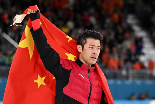 China's Ning Zhongyan celebrates after winning gold in the speed skating men's 1500m during the Milano Cortina 2026 Winter Olympic Games at Milano Speed Skating Stadium in Milan on February 19, 2026. (Photo by Daniel MUNOZ / AFP)