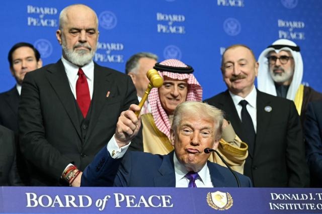 US President Donald Trump holds a gavel during a signing ceremony at the inaugural meeting of the "Board of Peace" at the US Institute of Peace in Washington, DC, on February 19, 2026. President Trump on Thursday gathers allies to inaugurate the "Board of Peace," his new institution focused on progress on Gaza but whose ambitions reach much further. Around two dozen world leaders or other senior officials have come to Washington for the meeting -- including several of Trump's authoritarian-leaning friends and virtually none of the European democrats that traditionally sign on to US initiatives. (Photo by SAUL LOEB / AFP)