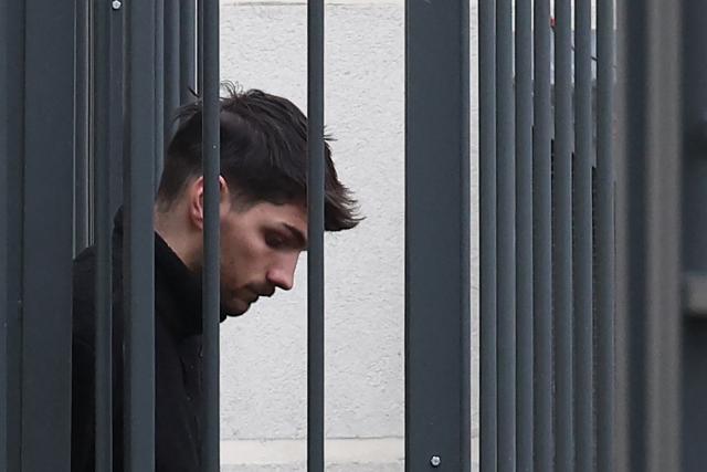 French parliamentary assistant Jacques-Elie Favrot looks down as he leaves the police station in Lyon, south-eastern France on February 19, 2026 before a hearing with a judge as part of an investigation into the death of a far-right activist, who died after sustaining a severe brain injury when he was reportedly attacked by some six people in the city. The Lyon prosecutor's office on February 19, 2026, has requested the indictment of seven individuals for the "intentional homicide" of 'Quentin'. The attack happened on the sidelines of a far-right protest against a hard-left politician speaking at a university in the south-eastern city of Lyon. (Photo by Alex MARTIN / AFP) / INTERNAL LEGAL REVIEW BY CLIENT RECOMMENDED PRIOR TO PUBLICATION