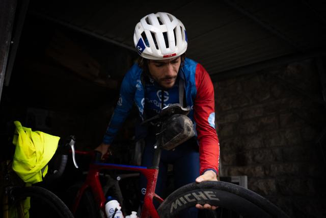 Groupama-FDJ's French cyclist Guillaume Martin-Guyonnet takes his bicycle from his parking as he prepares for a training session in Dives-sur-mer, north-western france on February 19, 2026. French cyclist Guillaume Martin Guyonnet was the best climber in the 2020 Tour of Spain, came third in the Criterium du Dauphine the same year, and finished eighth in the 2021 Tour de France. He is also the author of several books on philosophy and its application to sport. (Photo by Lou BENOIST / AFP)