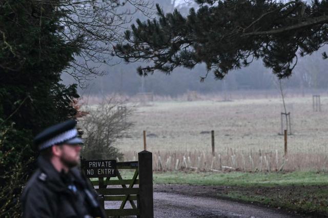 A policeman stands at an entrance to Wood Farm on the royal family's Sandringham Estate in Norfolk, eastern England on February 19, 2026, where former prince Andrew was arrested earlier in the day. Britain's royal family was in crisis on February 19 as former prince Andrew was in police custody after being arrested on suspicion of misconduct for his links to late US sex offender Jeffrey Epstein. (Photo by JUSTIN TALLIS / AFP)