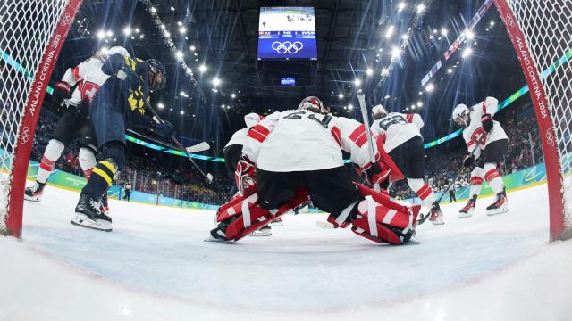 Switzerland's players control the puck during the women's bronze medal ice hockey match between Switzerland and Sweden at the Milano Santagiulia Ice Hockey Arena during the Milano Cortina 2026 Winter Olympic Games in Milan, on February 19, 2026. (Photo by POOL / AFP)