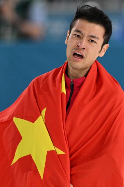 China's Ning Zhongyan celebrates after winning gold in the speed skating men's 1500m during the Milano Cortina 2026 Winter Olympic Games at Milano Speed Skating Stadium in Milan on February 19, 2026. (Photo by Daniel MUNOZ / AFP)