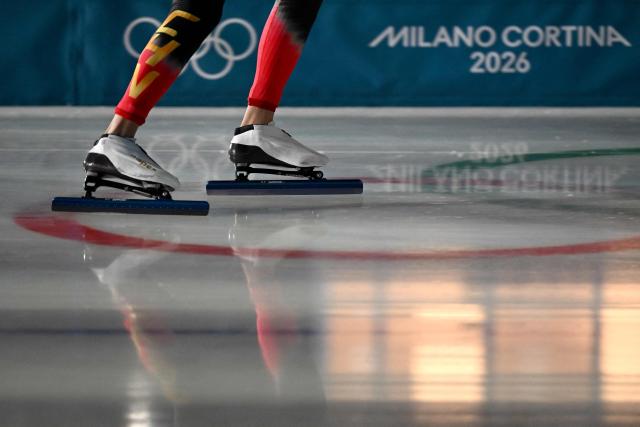A China's athlete competes in the speed skating men's 1500m during the Milano Cortina 2026 Winter Olympic Games at Milano Speed Skating Stadium in Milan on February 19, 2026. (Photo by Daniel MUNOZ / AFP)