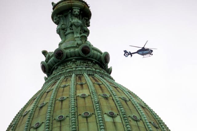 A police helicopter overflies the Congress building, where Argentina’s President Javier Milei’s labor reform is to be debated, in Buenos Aires on February 19, 2026. Shops and supermarkets closed, public transport was scarce and garbage went uncollected on February 19, 2026 as Argentine workers staged the fourth general strike of President Javier Milei's term, this time to protest labor reforms. (Photo by TOMAS CUESTA / AFP)