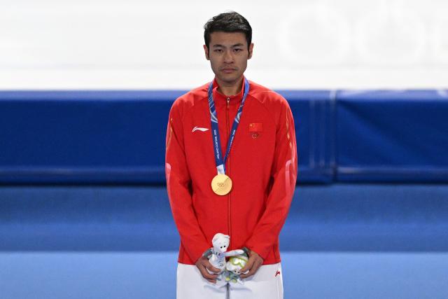 Gold medallist China's Ning Zhongyan poses on the podium of the speed skating men's 1500m during the Milano Cortina 2026 Winter Olympic Games at Milano Speed Skating Stadium in Milan on February 19, 2026. (Photo by Daniel MUNOZ / AFP)