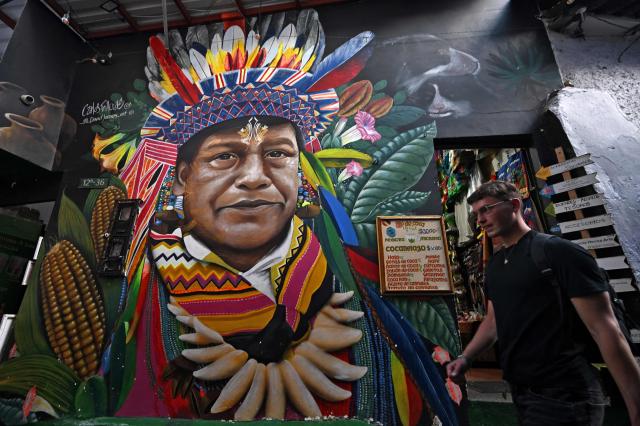 View of a mural on a street leading to Plaza del Chorro de Quevedo, a historic square considered the birthplace of the city and located in the Candelaria neighborhood, one of Bogota’s main tourist attractions, on February 17, 2026. (Photo by Raul ARBOLEDA / AFP)
