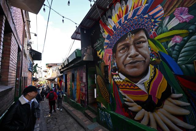View of a mural on a street leading to Plaza del Chorro de Quevedo, a historic square considered the birthplace of the city and located in the Candelaria neighborhood, one of Bogota’s main tourist attractions, on February 17, 2026. (Photo by Raul ARBOLEDA / AFP)