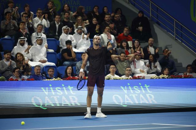 Russia's Karen Khachanov reacts during their men’s singles quarterfinal match against Spain's Carlos Alcaraz at the Qatar Open tennis tournament in Doha on February 19, 2026. (Photo by Karim JAAFAR / AFP)