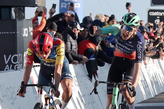 Decathlon CMA CGM Team French cyclist Paul Seixas (R) celebrates as he crosses the finish line in first place next to Lidl-Trek Spanish cyiclist Juan Ayuso during the second stage of the 52nd edition of the Volta ao Algarve, a 147.2 km race between Portimao and Foia, Monchique, on February 19, 2026. (Photo by João Matos / AFP)