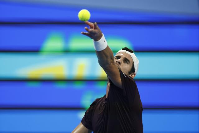 Russia's Karen Khachanov serves against Spain's Carlos Alcaraz during their men’s singles quarterfinal match at the Qatar Open tennis tournament in Doha on February 19, 2026. (Photo by Karim JAAFAR / AFP)