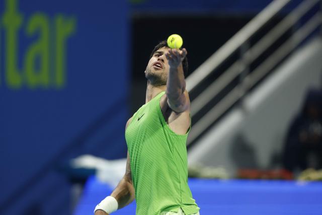 Spain's Carlos Alcaraz serves against Russia's Karen Khachanov during their men’s singles quarterfinal match at the Qatar Open tennis tournament in Doha on February 19, 2026. (Photo by Karim JAAFAR / AFP)