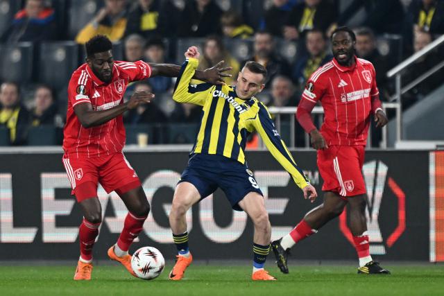 Nottingham Forest's Ivorian midfielder #06 Ibrahim Sangare (L) and Fenerbahce's Turkish forward #09 Muhammed Kerem Akturkoglu (C) fight for the ball during the UEFA Europa League - knockout round play-off first leg - football match between Fenerbahce SK and Nottingham Forest FC at the Sukru Saracoglu Stadium in Istanbul on February 19, 2026. (Photo by Ozan KOSE / AFP)