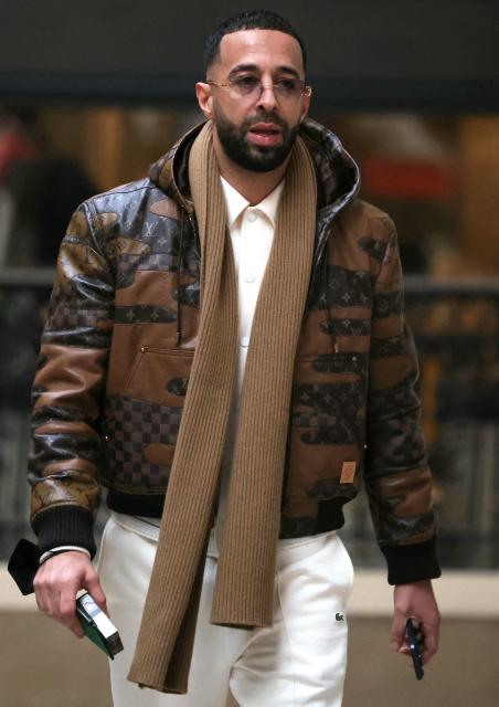 (FILES) French rapper Nabil Boukhobza aka Naps arrives to attend his trial on charge of raping a young woman in her sleep in a hotel in 2021, at the Palais de Justice of Paris, on February 16, 2026. Naps was sentenced to seven years in prison for rape, with an immediate committal order on February 19, 2026. (Photo by Thomas SAMSON / AFP)