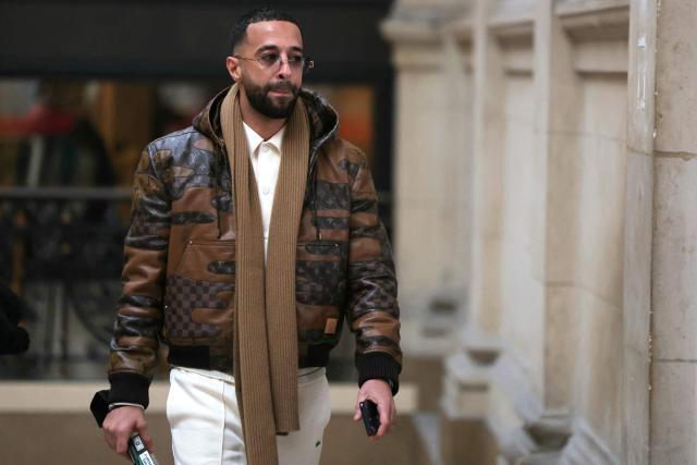 (FILES) French rapper Nabil Boukhobza aka Naps arrives to attend his trial on charge of raping a young woman in her sleep in a hotel in 2021, at the Palais de Justice of Paris, on February 16, 2026. Naps was sentenced to seven years in prison for rape, with an immediate committal order on February 19, 2026. (Photo by Thomas SAMSON / AFP)